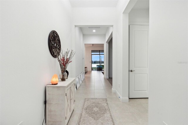 9132 Bernini Pl, Sarasota, FL 34240 - hall featuring light tile patterned floors, recessed lighting, and baseboards