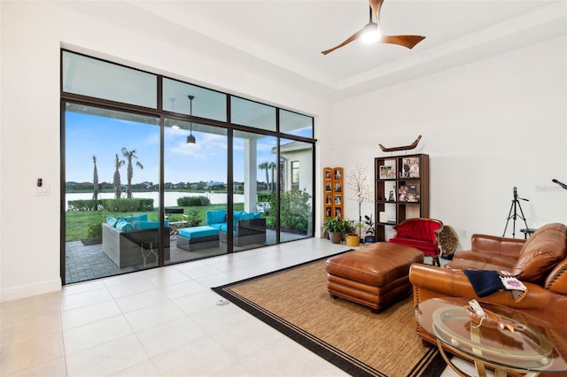 9132 Bernini Pl, Sarasota, FL 34240 - living room featuring a ceiling fan, a water view, and baseboards