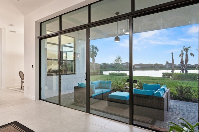 9132 Bernini Pl, Sarasota, FL 34240 - doorway with a water view, expansive windows, and tile patterned flooring