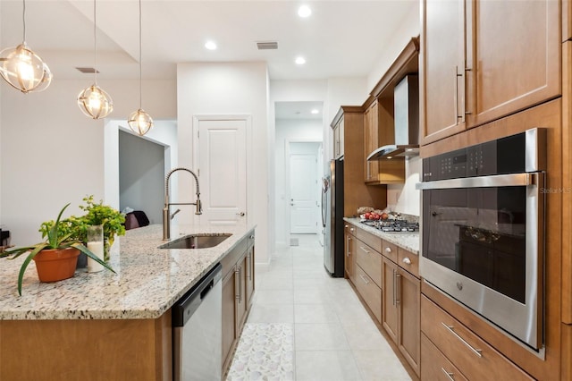 9132 Bernini Pl, Sarasota, FL 34240 - kitchen featuring a sink, stainless steel appliances, brown cabinets, light tile patterned floors, and wall chimney range hood