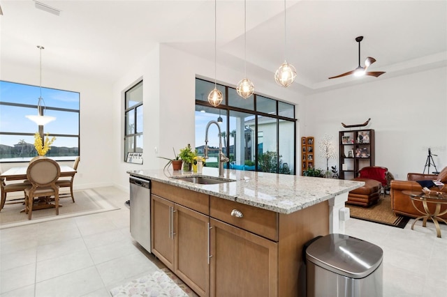 9132 Bernini Pl, Sarasota, FL 34240 - kitchen with a sink, dishwasher, light stone countertops, decorative light fixtures, and a center island with sink