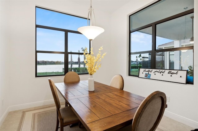 9132 Bernini Pl, Sarasota, FL 34240 - dining room with baseboards and a water view