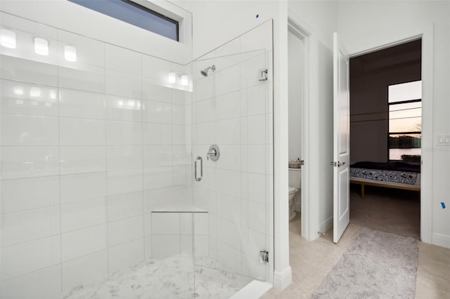 9132 Bernini Pl, Sarasota, FL 34240 - bathroom with ensuite bath, a shower stall, toilet, tile patterned floors, and baseboards