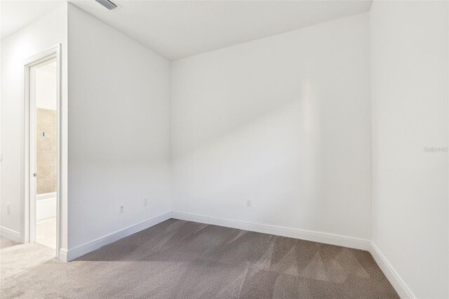 9132 Bernini Pl, Sarasota, FL 34240 - empty room with dark carpet and baseboards