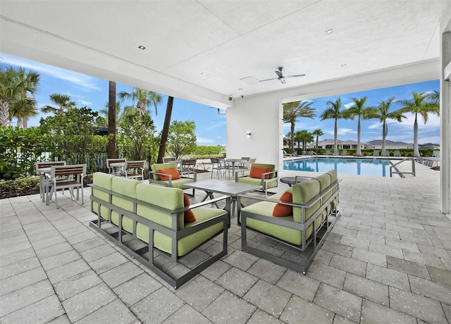 9132 Bernini Pl, Sarasota, FL 34240 - view of patio / terrace with outdoor dining space, an outdoor pool, and a ceiling fan