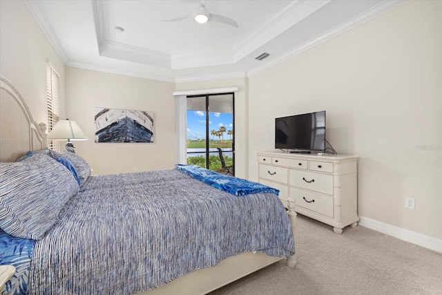 23503 Waverly Cir, Venice, FL 34293 - bedroom with a raised ceiling, access to outside, light colored carpet, crown molding, and a ceiling fan