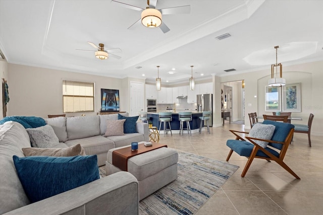 23503 Waverly Cir, Venice, FL 34293 - living room featuring a tray ceiling, ceiling fan, crown molding, light tile patterned flooring, and recessed lighting