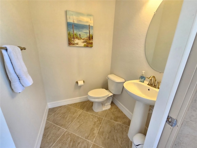 bathroom with tile patterned flooring and toilet