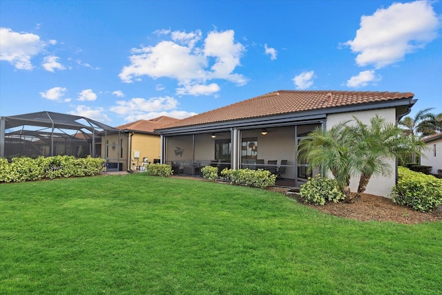 23503 Waverly Cir, Venice, FL 34293 - back of house with a tiled roof, stucco siding, and a yard