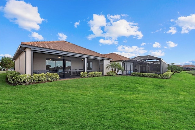 back of house featuring a lawn and a lanai