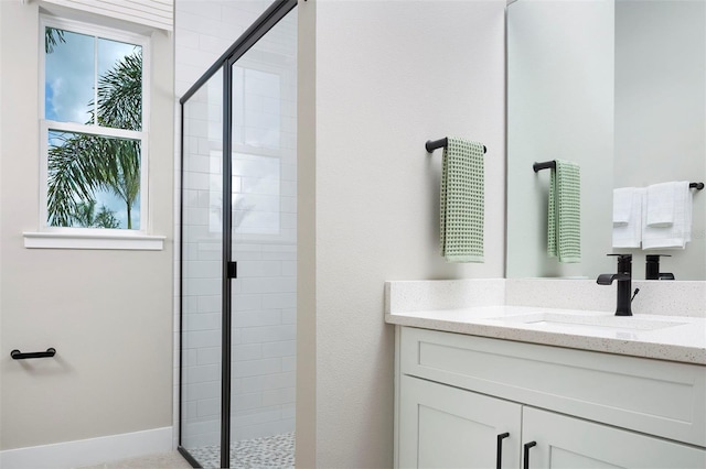 bathroom featuring vanity and a shower with door