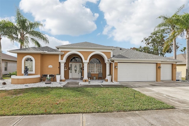 view of front of house with a front yard and a garage