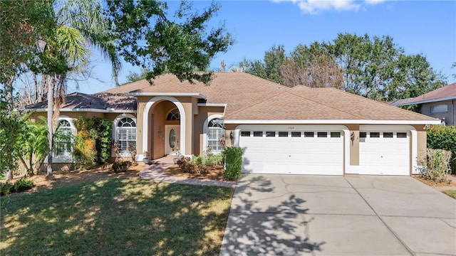 view of front of home with a front yard and a garage