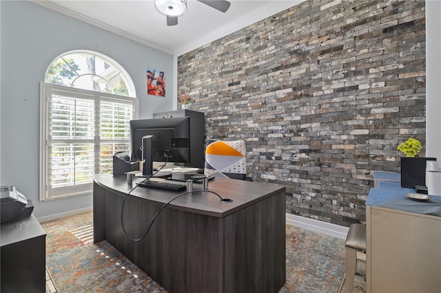 office featuring crown molding, plenty of natural light, ceiling fan, and brick wall