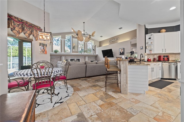 kitchen with backsplash, stainless steel dishwasher, ceiling fan, decorative light fixtures, and white cabinetry