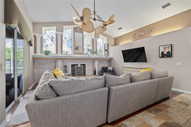 living room with ceiling fan, hardwood / wood-style floors, a healthy amount of sunlight, and vaulted ceiling