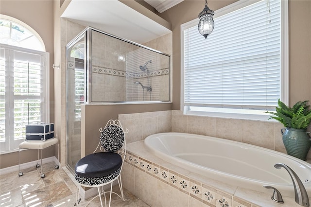 bathroom featuring shower with separate bathtub