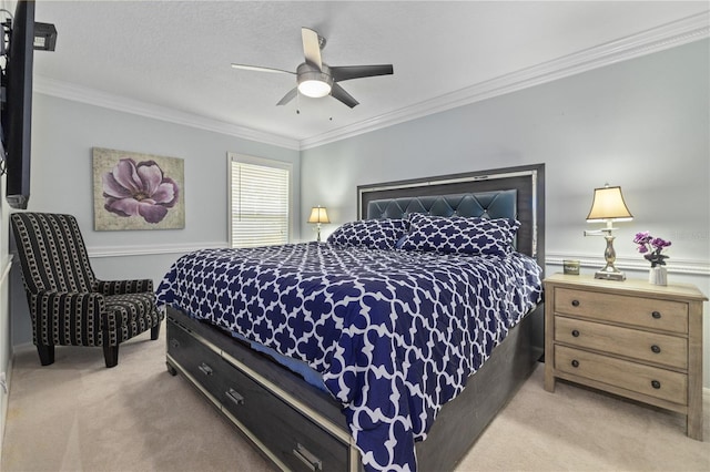 carpeted bedroom with ceiling fan, crown molding, and a textured ceiling