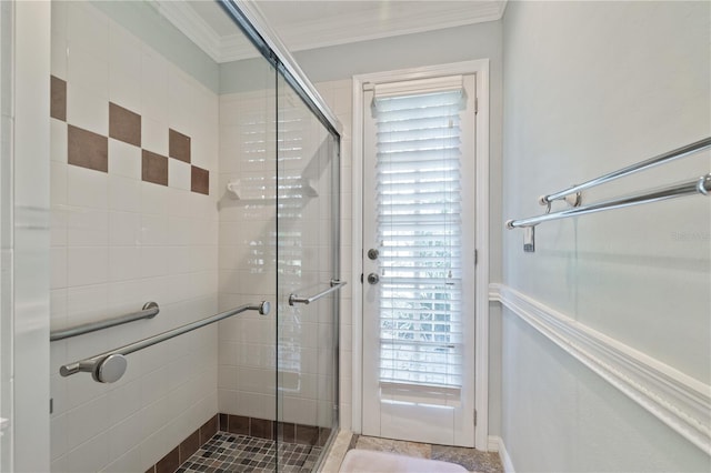 bathroom featuring crown molding and a shower with shower door