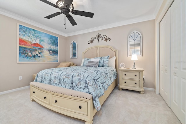 carpeted bedroom with ceiling fan, a closet, and crown molding