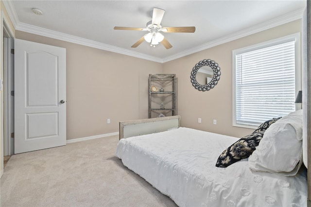 carpeted bedroom featuring ceiling fan and ornamental molding