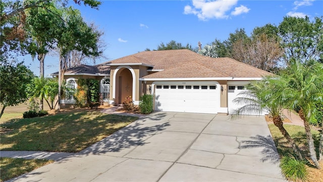 view of front facade with a garage and a front lawn