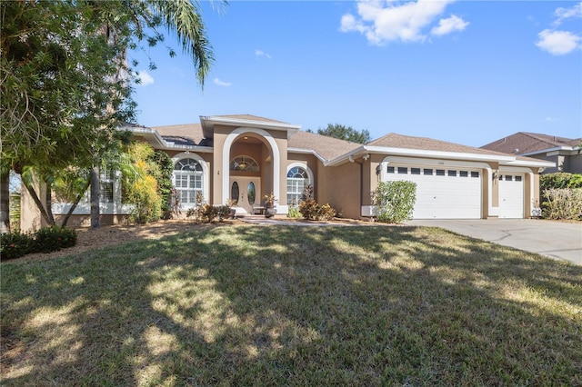 mediterranean / spanish home with a front yard and a garage