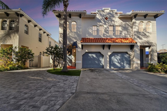 mediterranean / spanish house featuring a garage