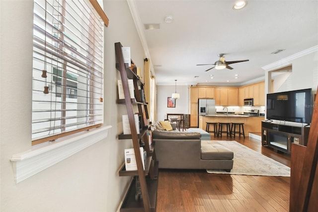 living room featuring crown molding, ceiling fan, and dark hardwood / wood-style flooring