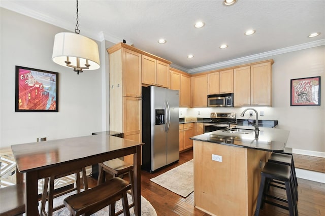 kitchen featuring stainless steel appliances, hanging light fixtures, sink, and light brown cabinets