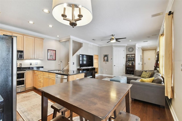 kitchen featuring stainless steel appliances, dark hardwood / wood-style flooring, sink, and light brown cabinetry