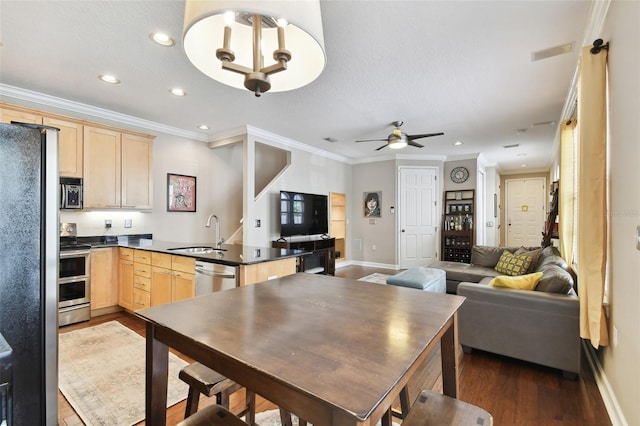 102 S Moody Ave Unit 3, Tampa, FL 33609 - kitchen featuring light brown cabinetry, stainless steel appliances, a sink, dark countertops, and recessed lighting