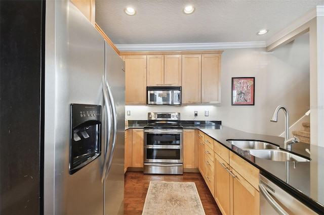 kitchen featuring stainless steel appliances, ornamental molding, sink, and light brown cabinetry