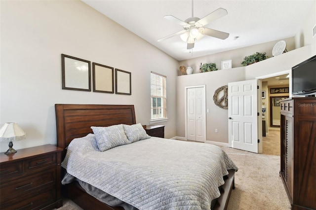 bedroom with light colored carpet, ceiling fan, and a closet