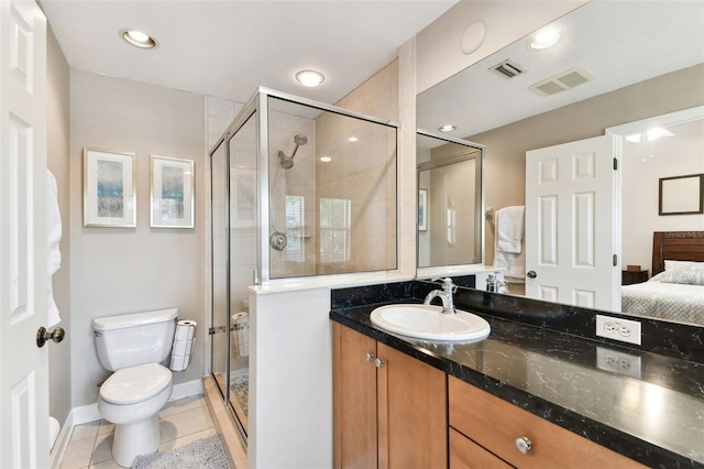 bathroom featuring vanity, a shower with shower door, tile patterned floors, and toilet