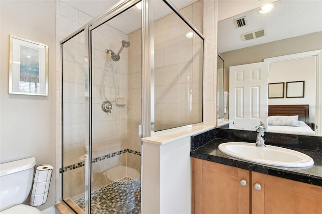 bathroom featuring vanity, toilet, and walk in shower