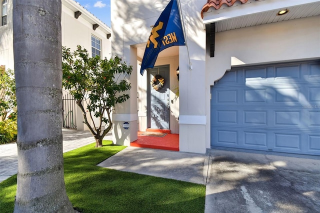 doorway to property with a garage