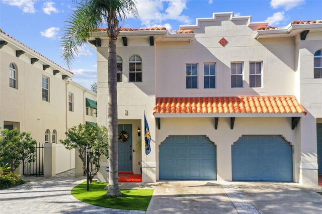 mediterranean / spanish-style house with a garage