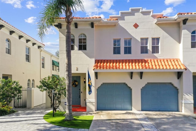 102 S Moody Ave Unit 3, Tampa, FL 33609 - mediterranean / spanish house with a tiled roof, an attached garage, driveway, and stucco siding
