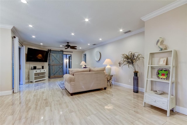 living room featuring a barn door, ceiling fan, and ornamental molding