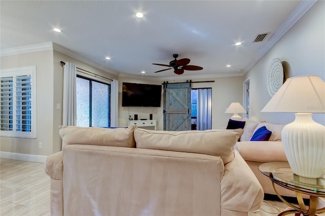 living room with a barn door, ceiling fan, and crown molding