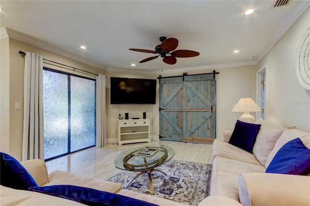 living room with ceiling fan, a barn door, and ornamental molding