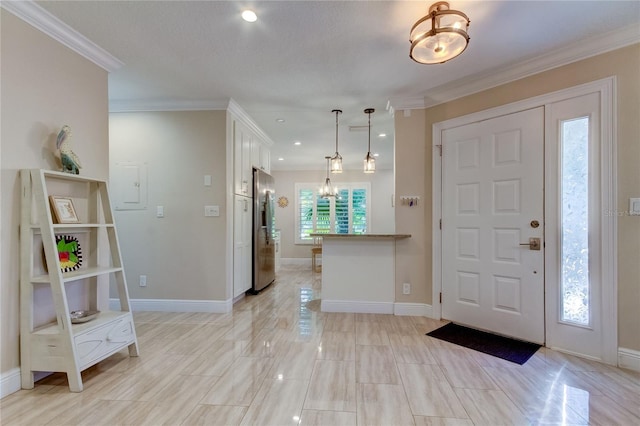 entryway featuring ornamental molding and an inviting chandelier