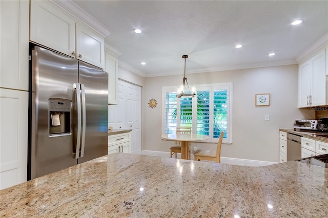 kitchen with white cabinets, pendant lighting, light stone counters, and stainless steel appliances