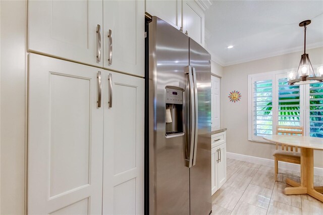 kitchen featuring a notable chandelier, white cabinets, crown molding, stainless steel refrigerator with ice dispenser, and decorative light fixtures