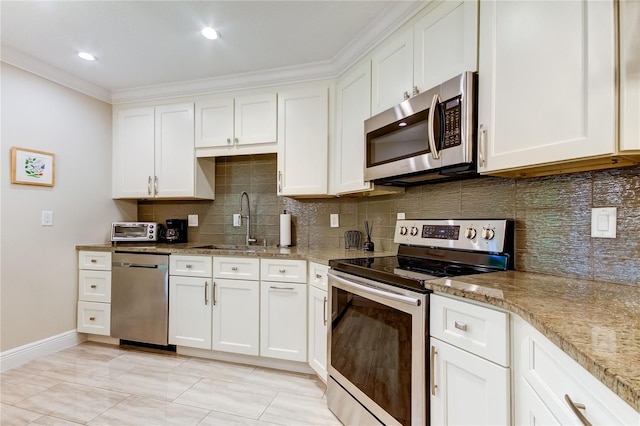 kitchen featuring appliances with stainless steel finishes, white cabinetry, and sink