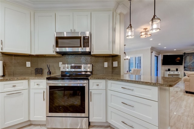 kitchen with pendant lighting, white cabinets, and appliances with stainless steel finishes