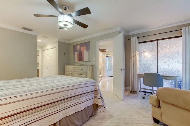 bedroom with ceiling fan, light colored carpet, ornamental molding, and a closet