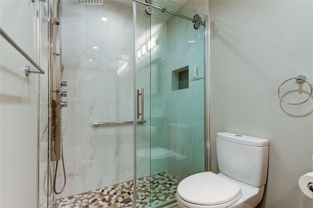 bathroom with toilet and an enclosed shower