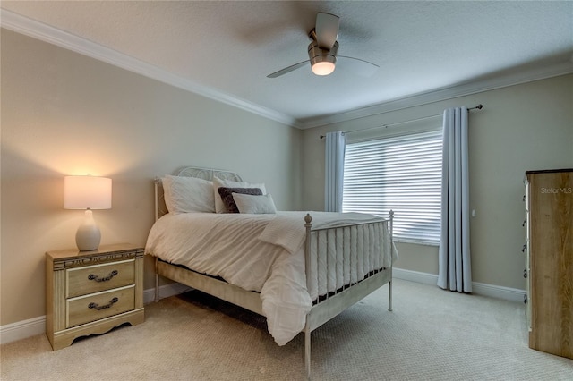 carpeted bedroom featuring ceiling fan and crown molding